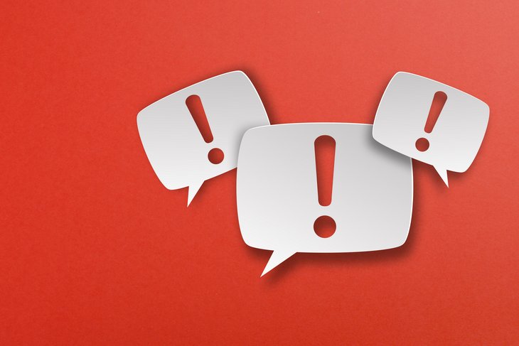 Exclamation mark with speech bubbles on red background